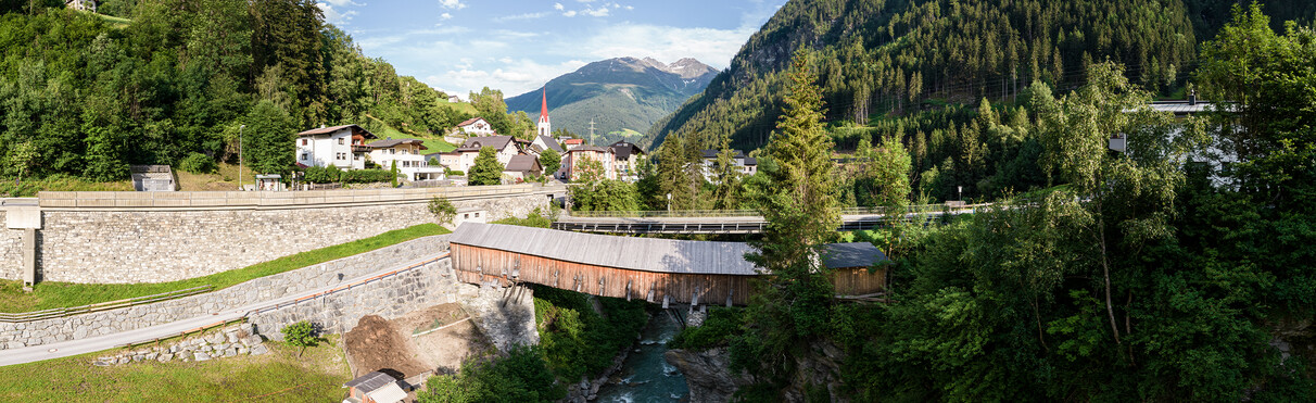 The rustic Rosanna bridge spanning over the Rosanne river in Strengen