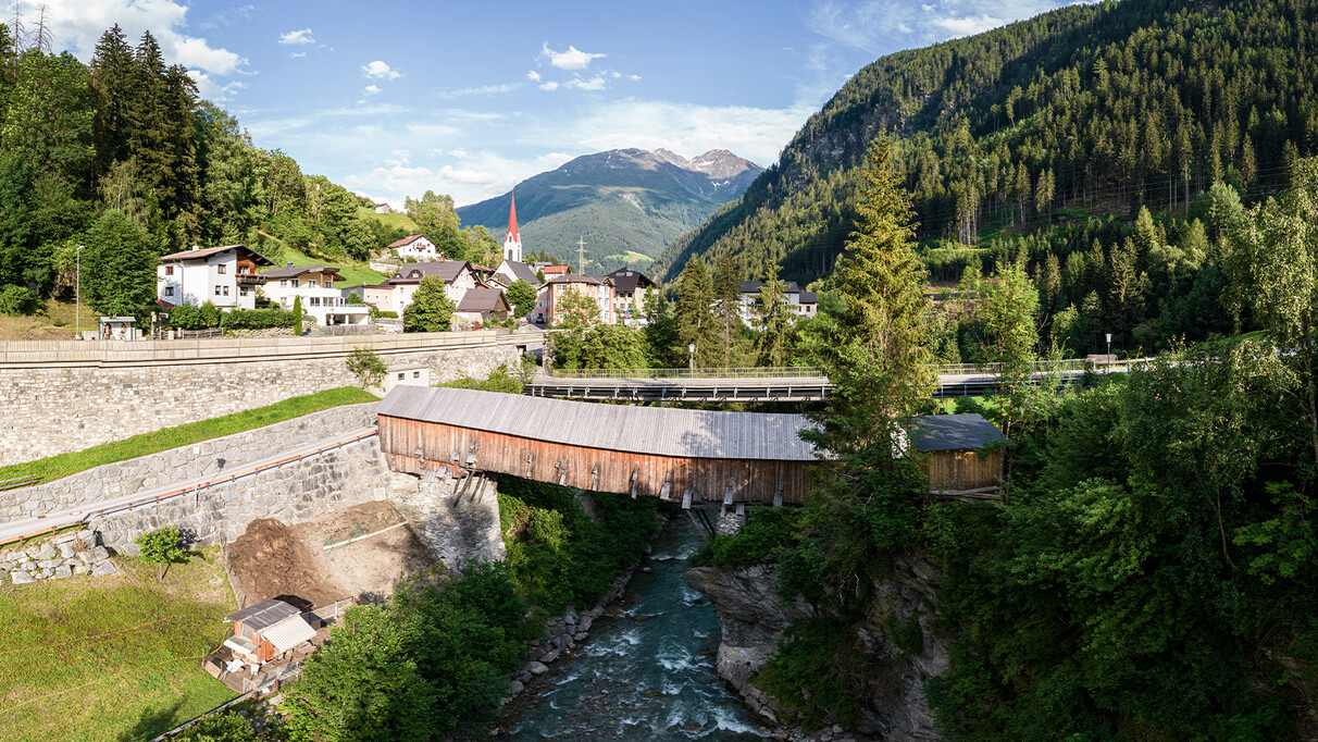 The rustic Rosanna bridge spanning over the Rosanne river in Strengen