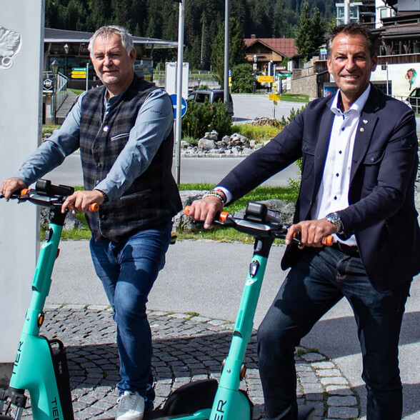 Helmut Mall and Gerhard Eichhorn in on turqoise TIER-Scooter St. Anton am Arlberg