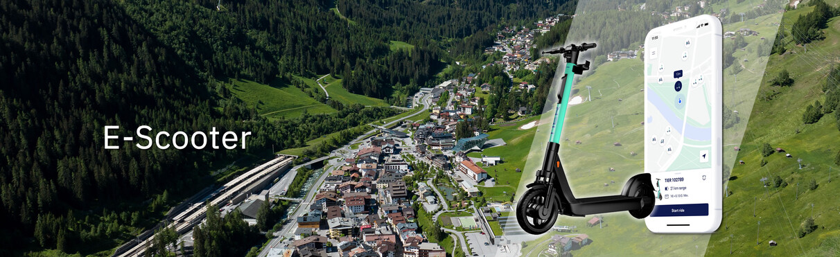 Campaign image for e-scooter rental in St. Anton am Arlberg – aerial view of the village with scooter and app interface in the foreground.