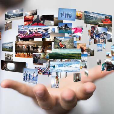 A hand displays floating images of leisure and nature activities.