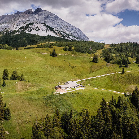 Drone shot of Alpe Dawin, which lies on a green pasture slope high on the mountain.