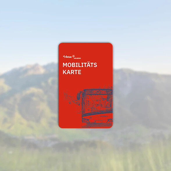Red St. Anton Mobility Card featuring a drawn bus design in front of a blurred mountain backdrop.