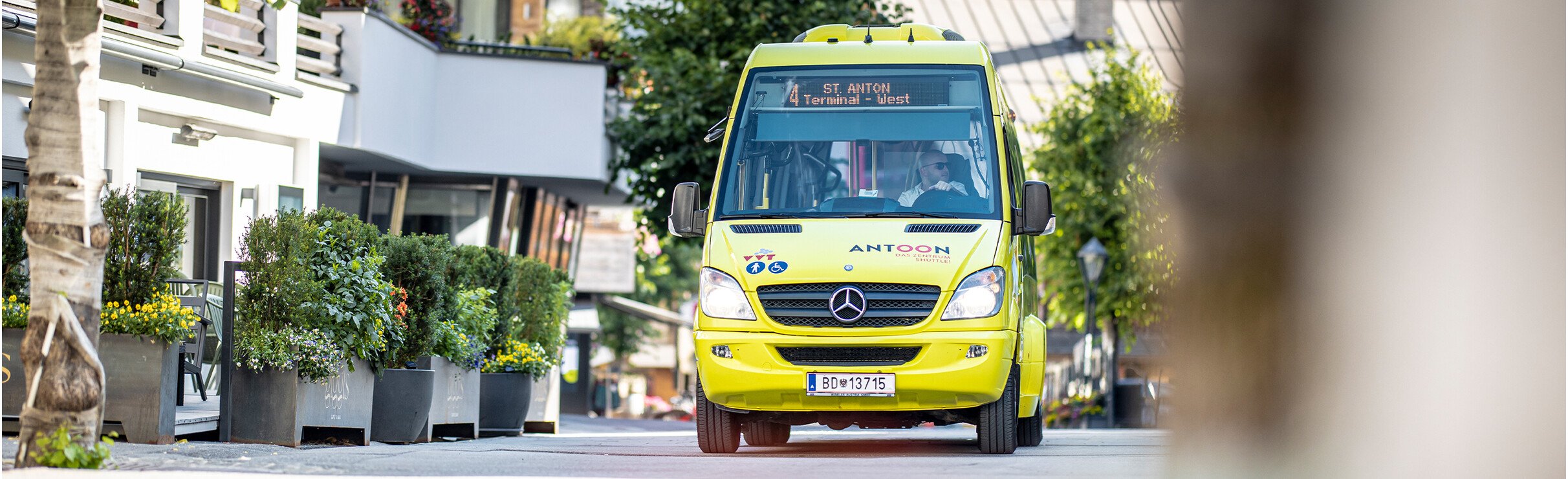 In de zomer rijdt de gele dorpsbus door het centrum van St. Anton am Arlberg.