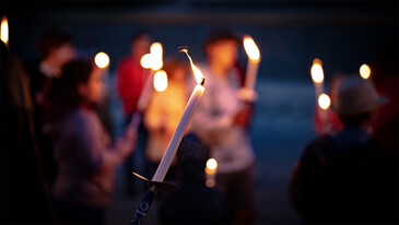 People hike with torches through the night – a magical and communal alpine experience.