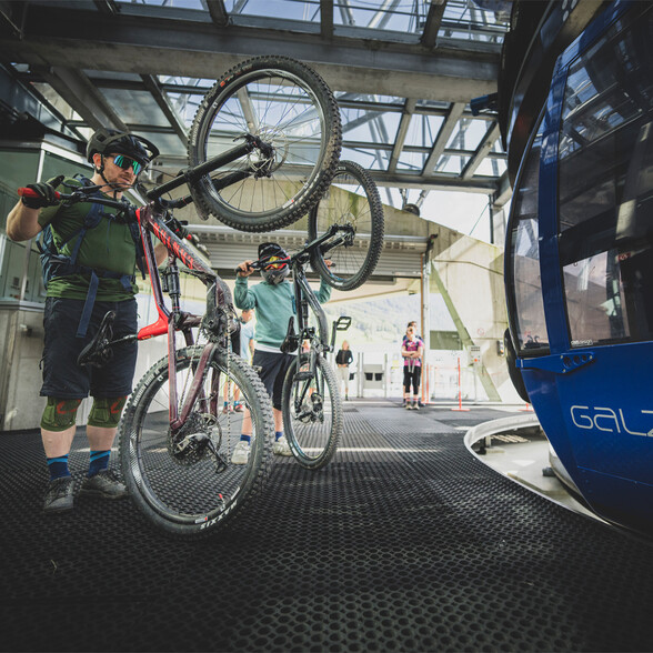 Two mountain bikers wait for the Galzigbahn gondola to board their bikes.