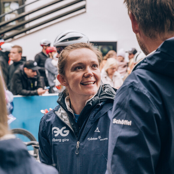Katie Austin smiles for the camera while working in the finish area of the Arlberg Giro.