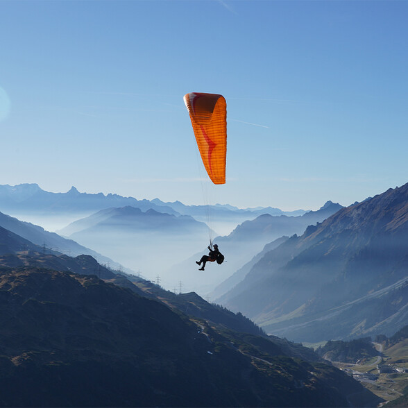 Paraglider flying above impressive Alpine panorama