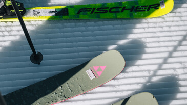 Ski rental Pair of skis on snow with one ski pole and a second pair of skis in the background