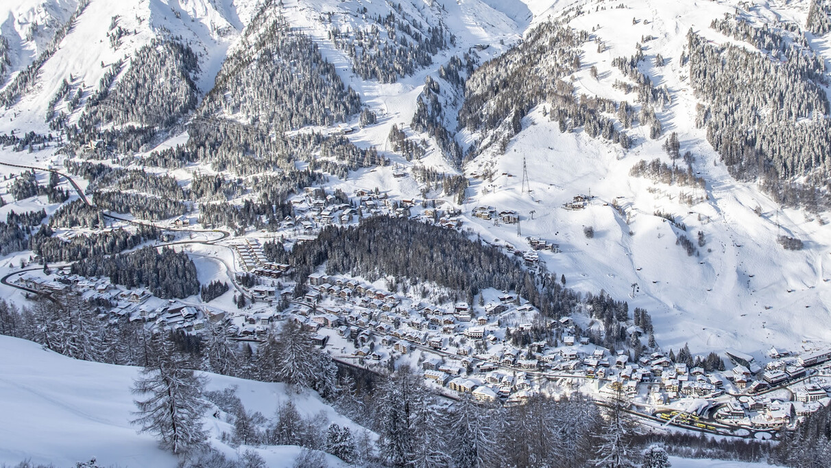 St. Anton am Arlberg in winter, covered in snow with a view of the valley runs of the ski area