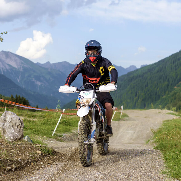 A motorcyclist wearing protective clothing rides on a trail in the EldoRADo in the Verwall valley near St. Anton am Arlberg.