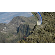 Gleitschirm startet nahe Felskante in grüner Bergwelt / Paraglider launching near rocky edge in green alpine scenery