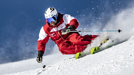 Ski instructor carving powerfully through fresh powder in St. Anton.