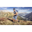 Ein Mann joggt auf einem herbstlichen Berghang mit weitem Blick ins Tal / A man jogs on an autumnal mountain slope with a wide view into the valley