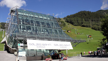 Galzigbahn Cable Car Station in summer in front of a green meadow