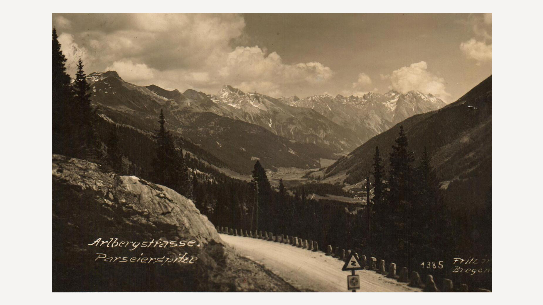 Panoramablick ins Stanzertal mit Bergstraße im Vordergrund und hoher Bergkette im Hintergrund / Panoramic view into the Stanzertal valley with a mountain road in the foreground and a high mountain range in the background