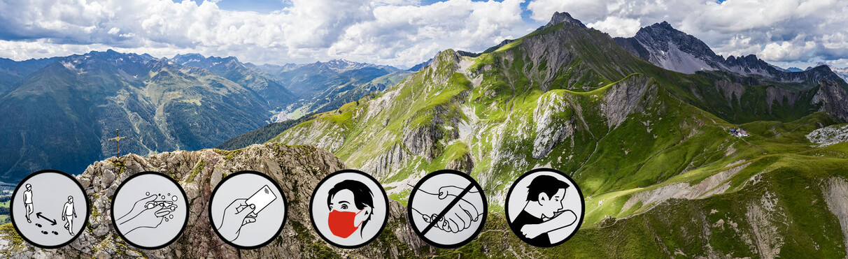 Summer mountain scenery with green meadows and a blue sky. Six icons illustrate COVID-19 safety measures such as handwashing, keeping distance, wearing a mask, and being considerate.